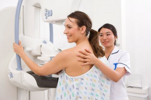 Radiologist helping patient with mammogram