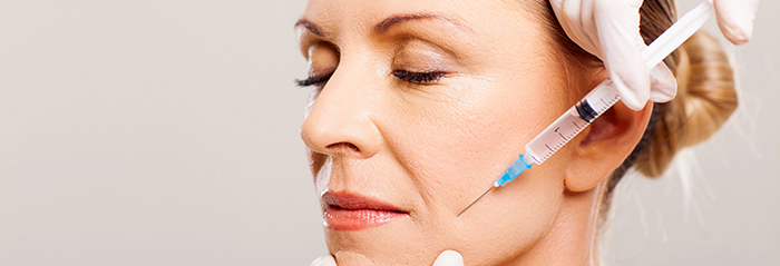 A woman receives a filler injection.